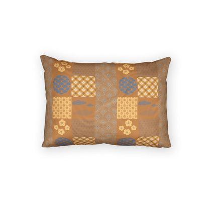 A rectangular decorative throw pillow with a patchwork-style Japanese-inspired pattern in warm brown, beige, and muted blue, shown against a plain white background.