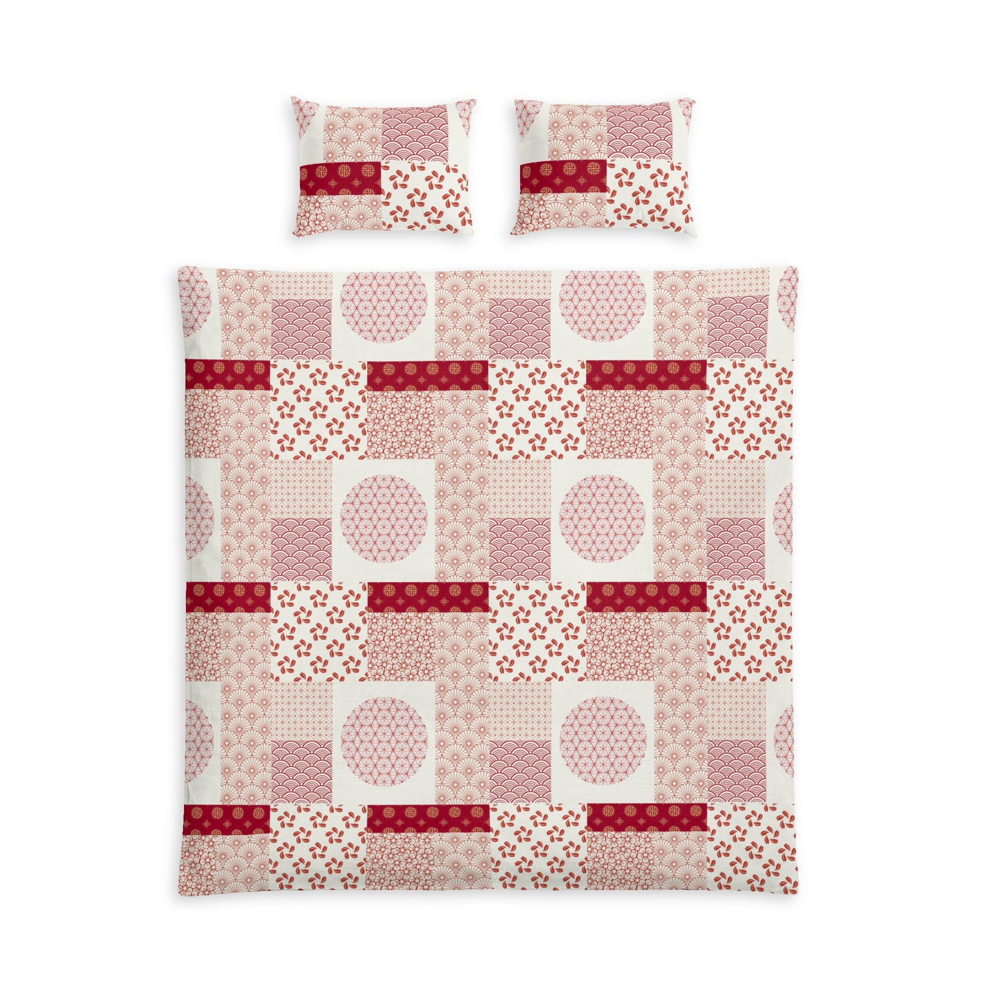 A bedding set featuring a patchwork quilt and two matching pillowcases with a geometric and floral patchwork pattern in shades of pink, red, and white.