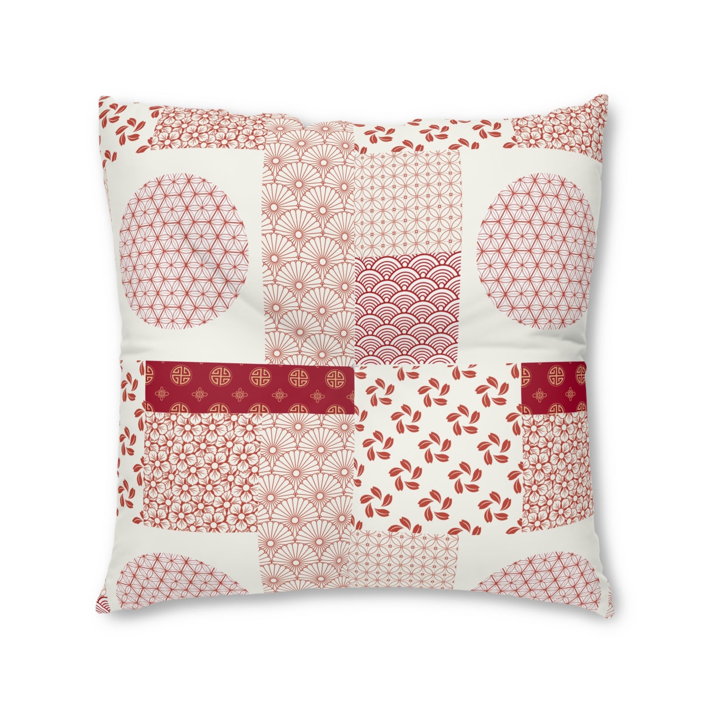 A square decorative throw pillow featuring a patchwork design of traditional Japanese-inspired patterns in red and pink on an off-white background, isolated on a white studio background.