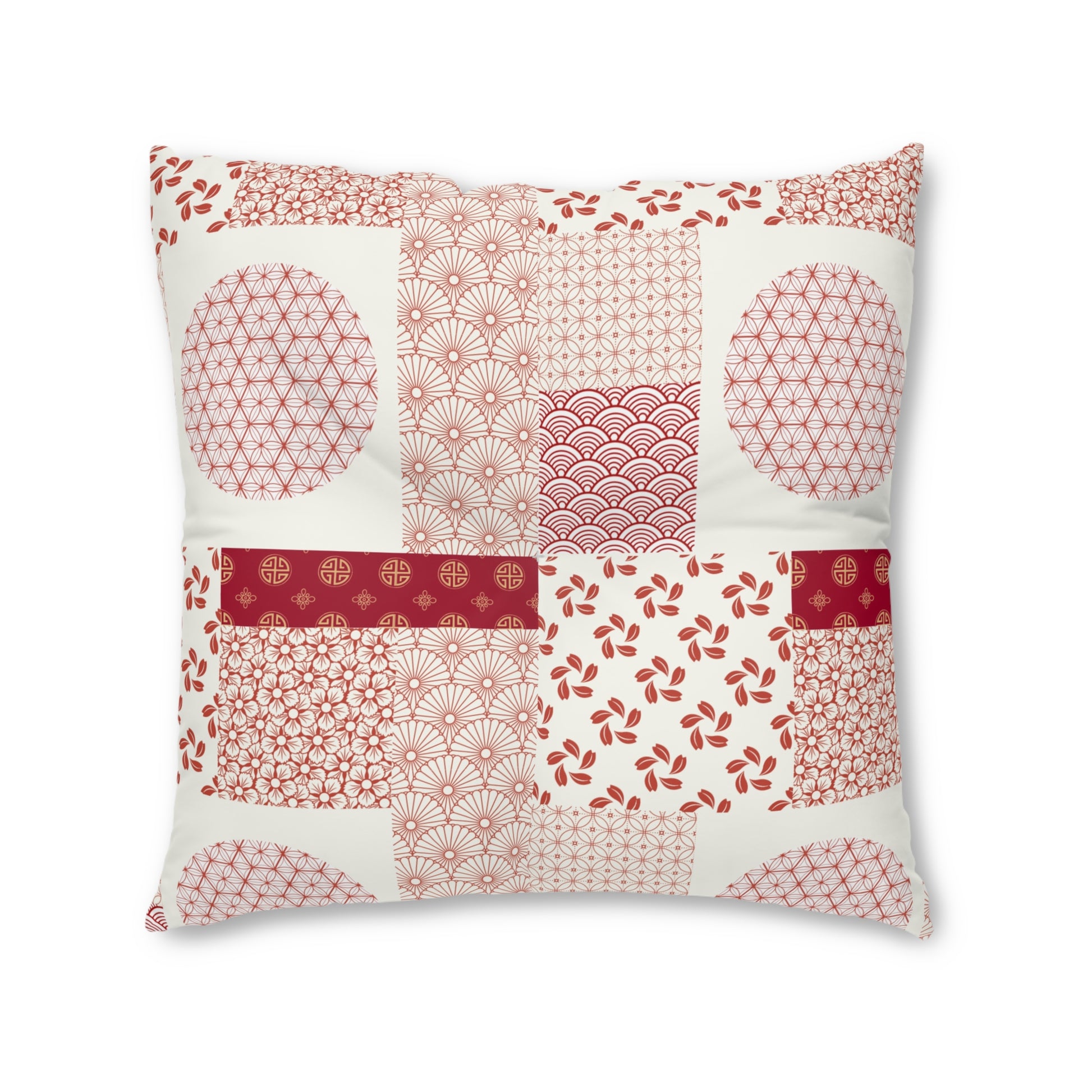 A square decorative throw pillow featuring a patchwork design of traditional Japanese-inspired patterns in red and pink on an off-white background, isolated on a white studio background.