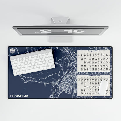 Desk setup with a large desk mat featuring a map of Hiroshima, a keyboard, and a computer monitor.
