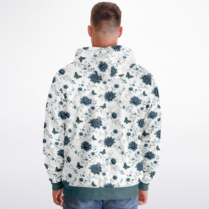 A man viewed from behind wearing a white hooded sweatshirt with a dark blue floral and butterfly pattern, paired with blue jeans, against a plain white background.