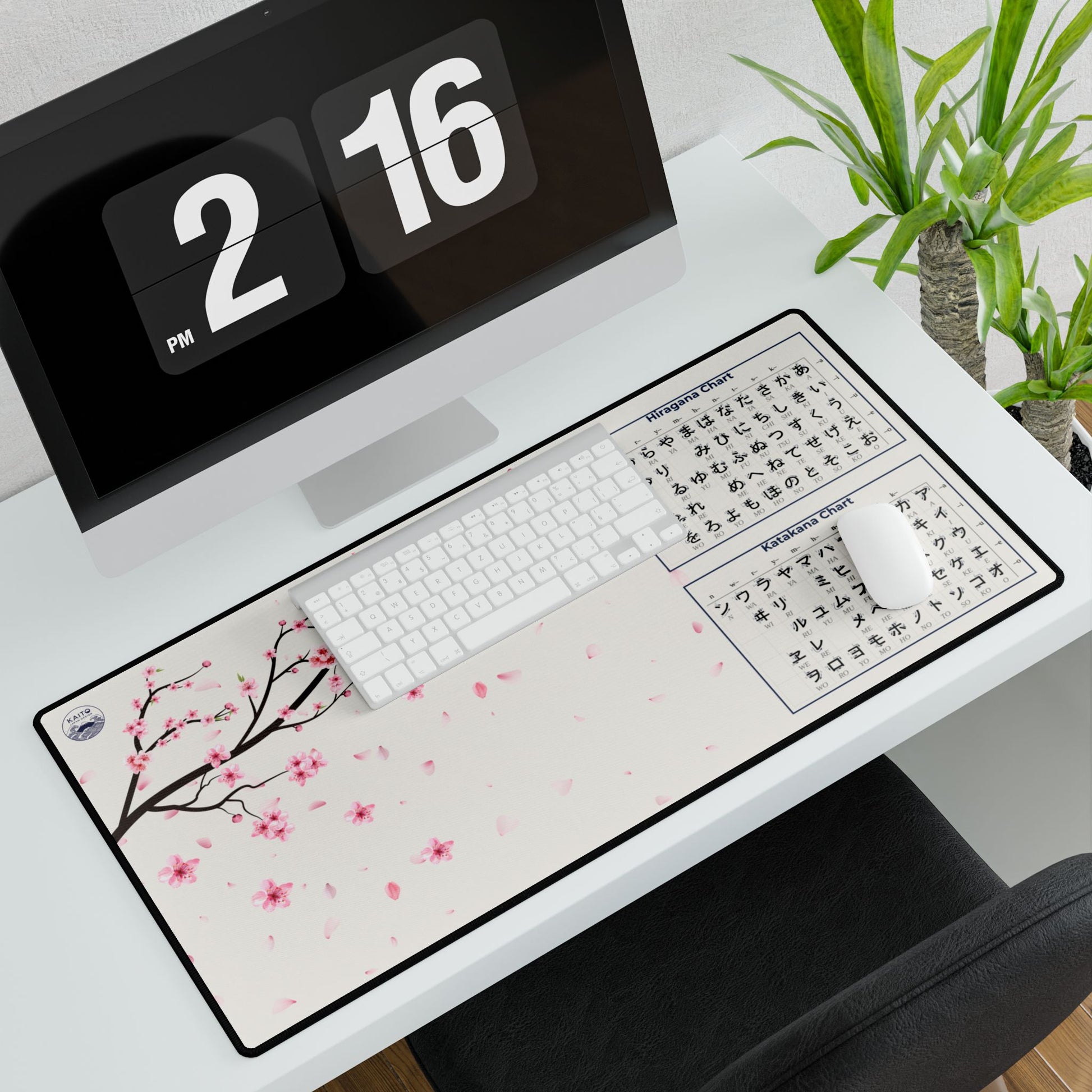Desk setup with a cherry blossom design mouse pad, keyboard, and digital clock.