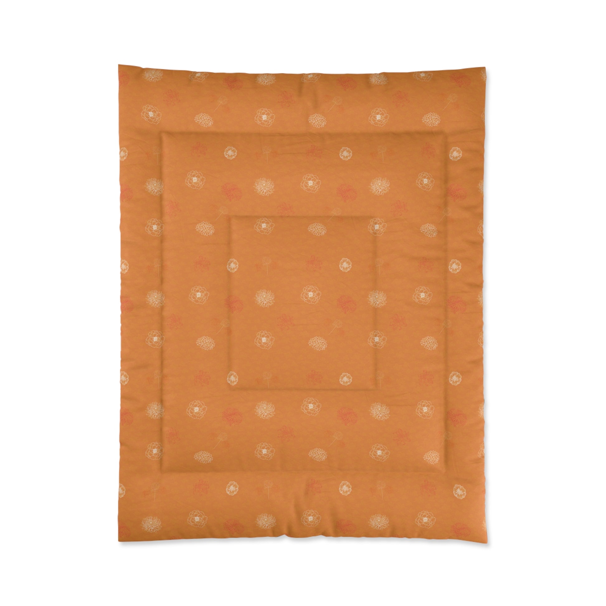 An orange quilted comforter or mattress protector featuring a repeating pattern of small white and pink floral motifs, shown flat against a white background.