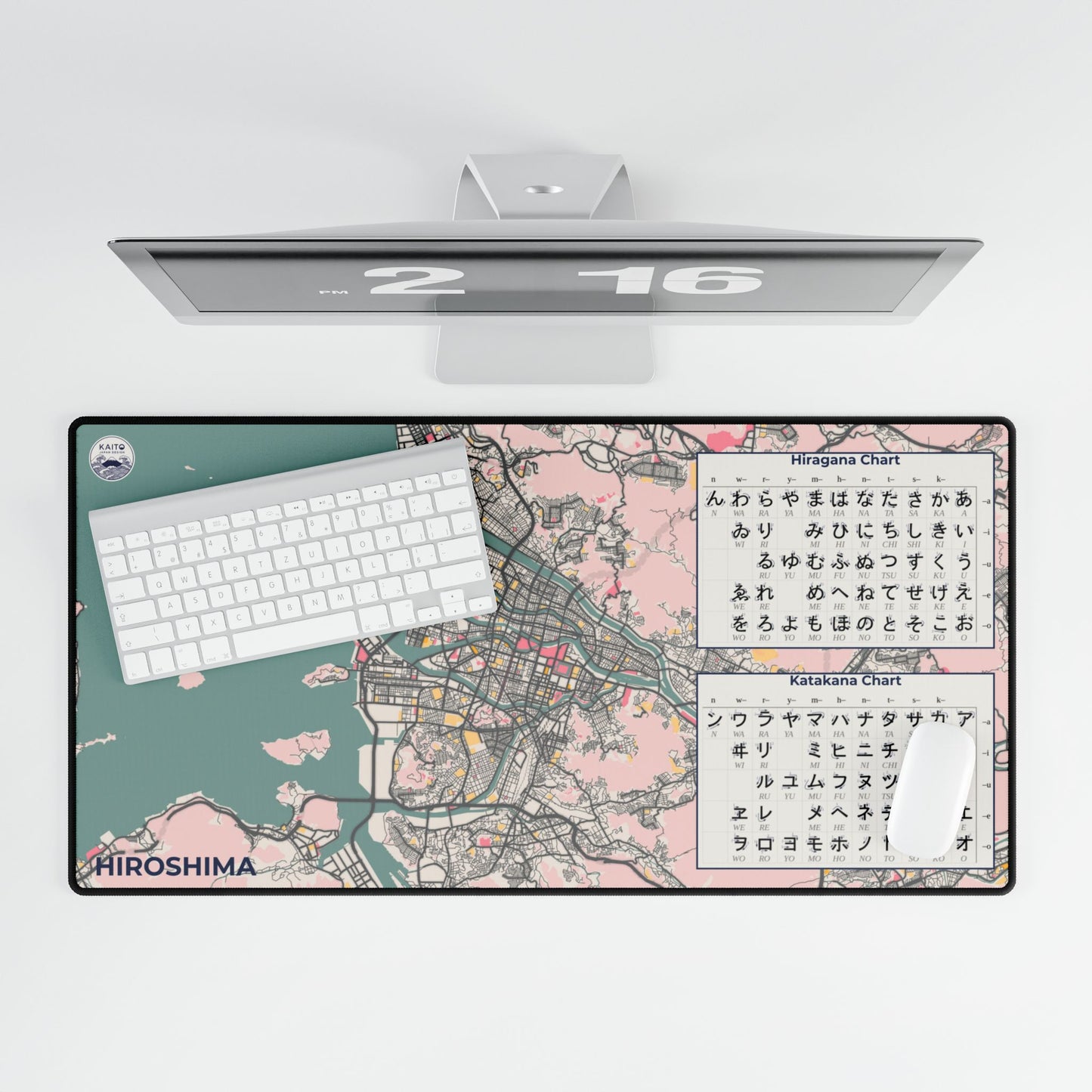 Top-down view of a vintage-style cream and charcoal desk mat featuring the street map of Hiroshima, Japan, styled with a laptop and a cup of coffee.