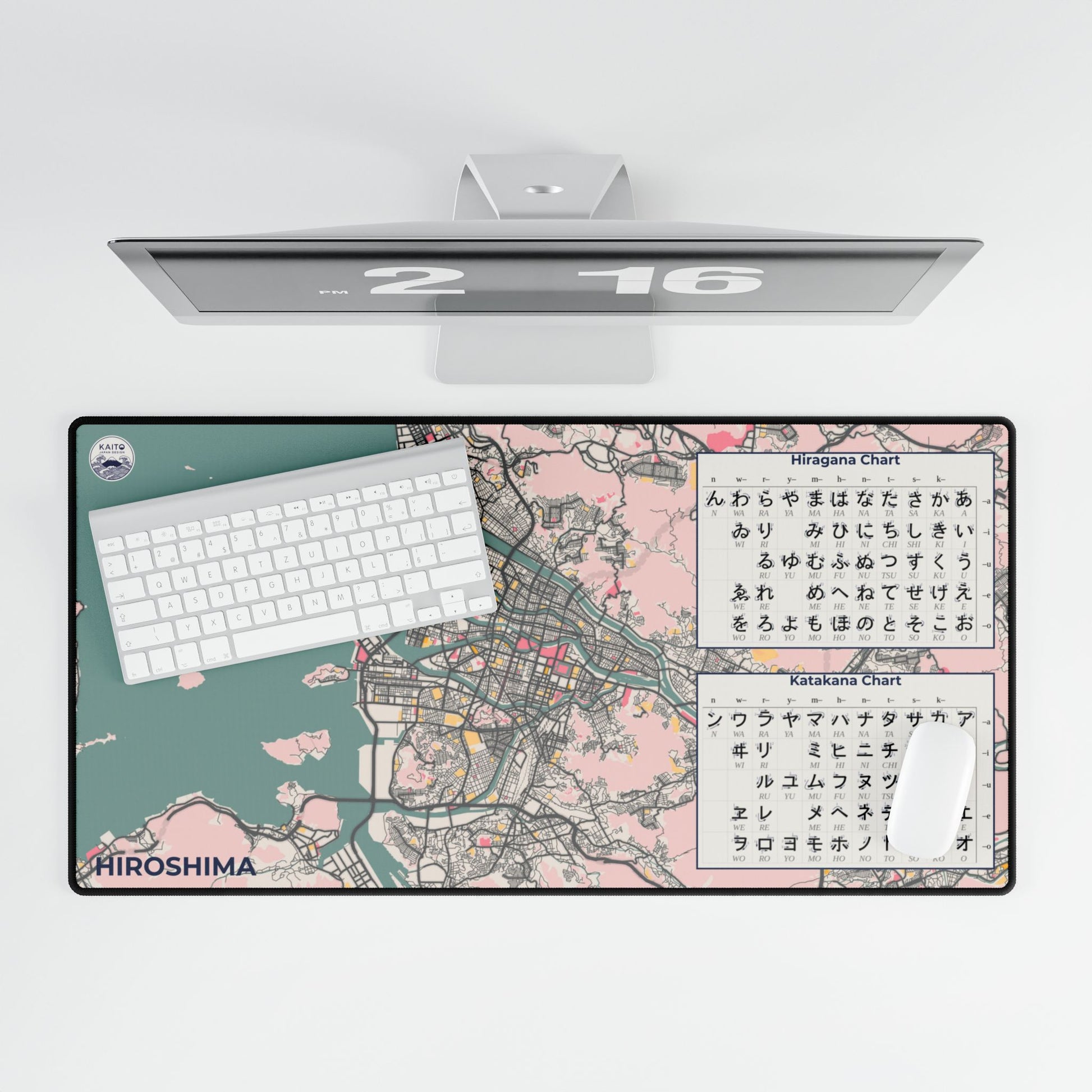 Top-down view of a vintage-style cream and charcoal desk mat featuring the street map of Hiroshima, Japan, styled with a laptop and a cup of coffee.