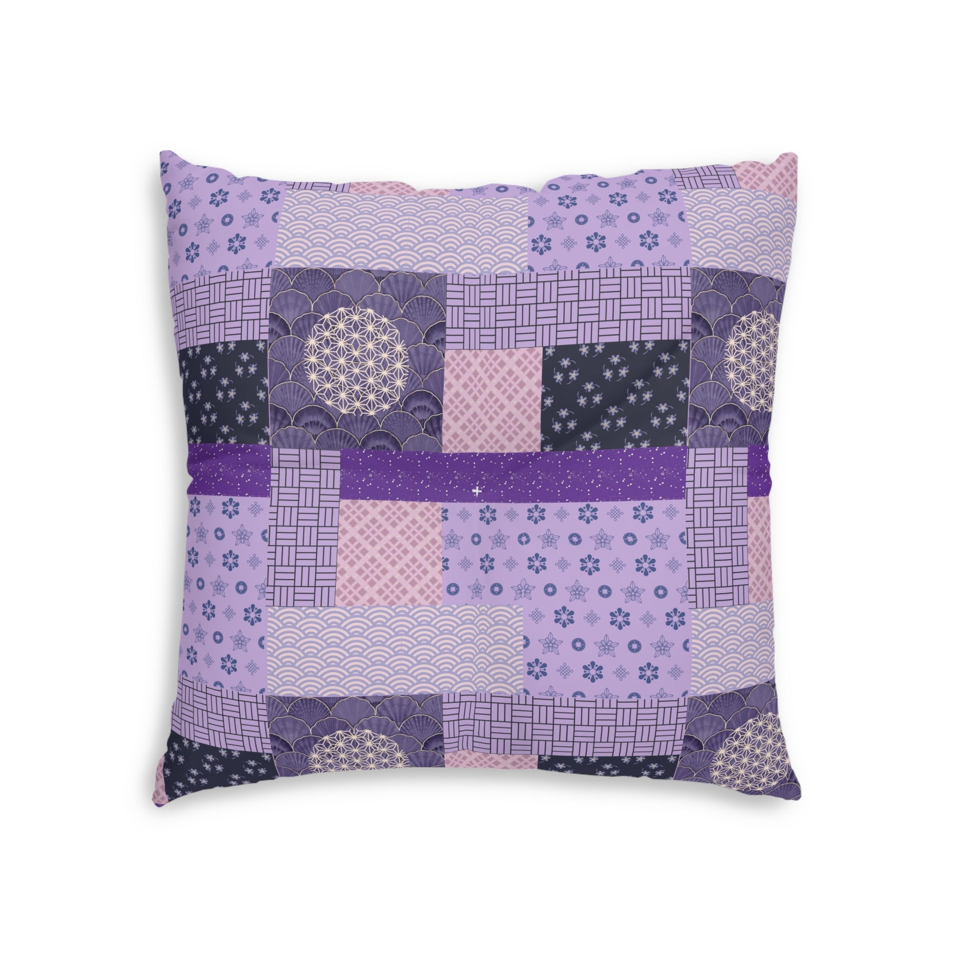 A square decorative throw pillow featuring a patchwork design of various Japanese-inspired patterns in shades of purple, pink, and navy blue, set against a plain white background.