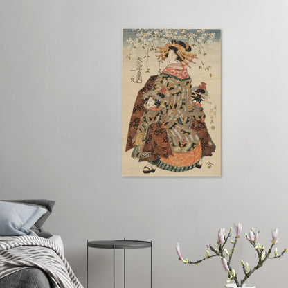 Traditional Japanese artwork of a woman in a kimono on a gray wall above a bed.