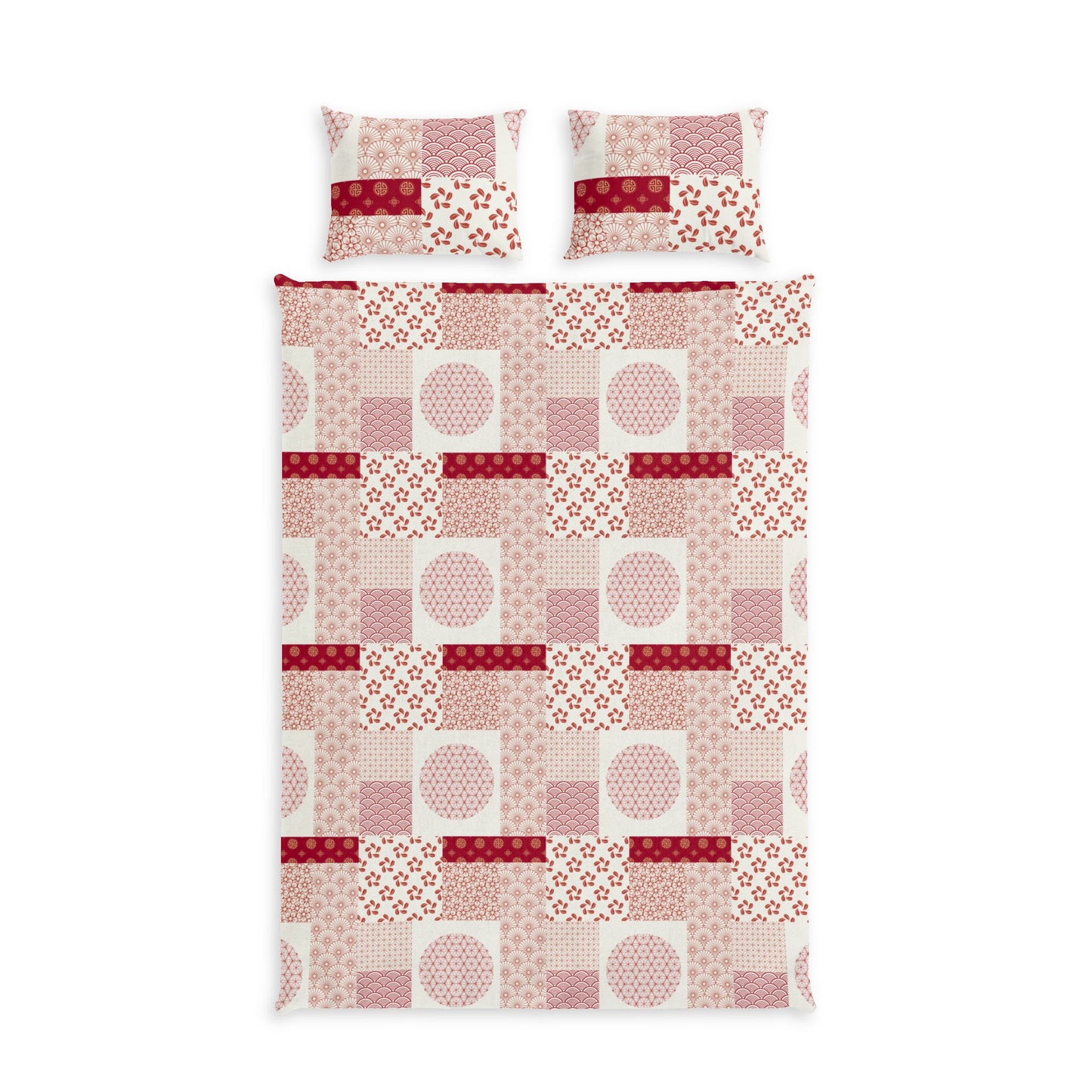 A bedding set featuring a patchwork quilt and two matching pillowcases with a geometric patchwork pattern in shades of pink, red, and white.