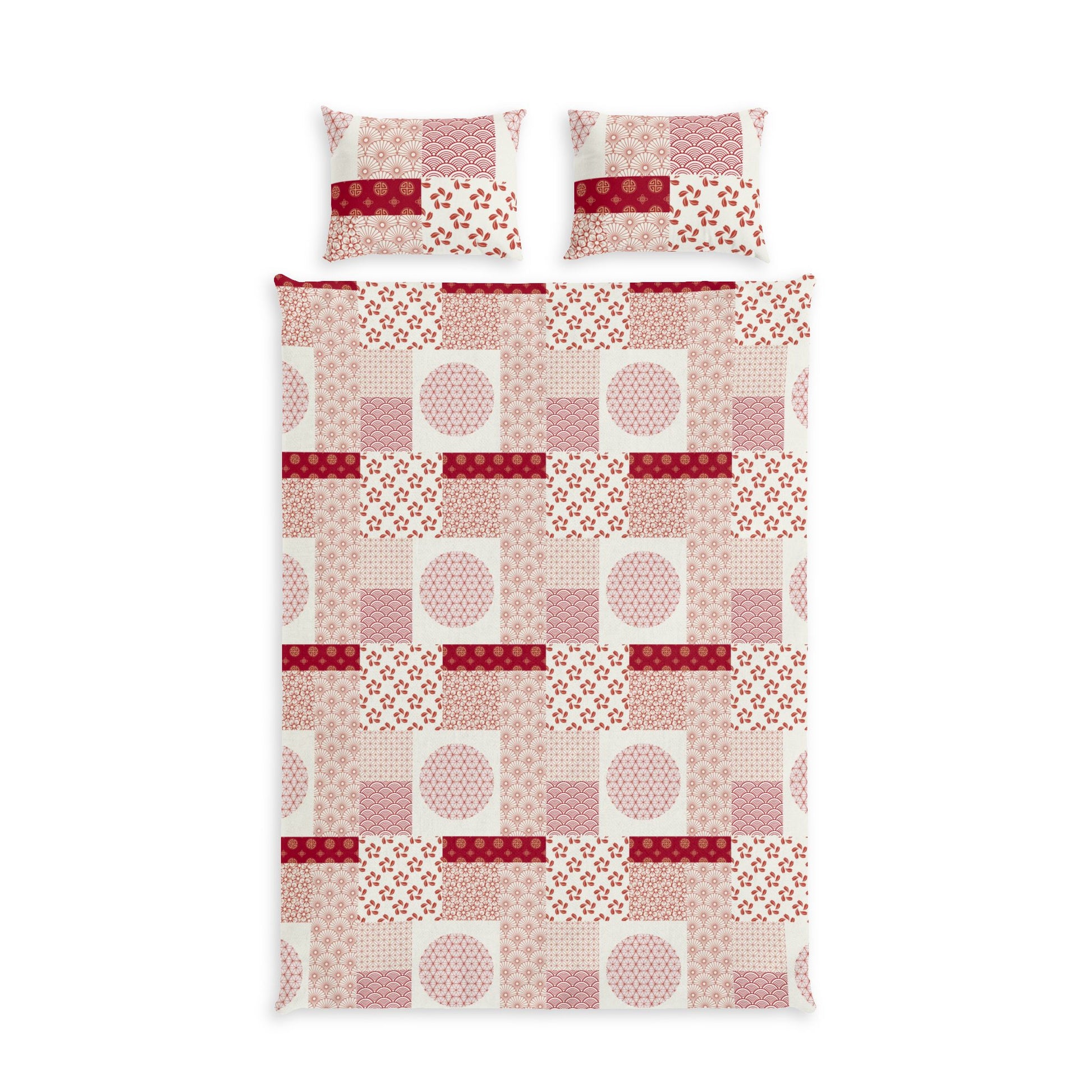 A bedding set featuring a patchwork quilt and two matching pillowcases with a geometric patchwork pattern in shades of pink, red, and white.