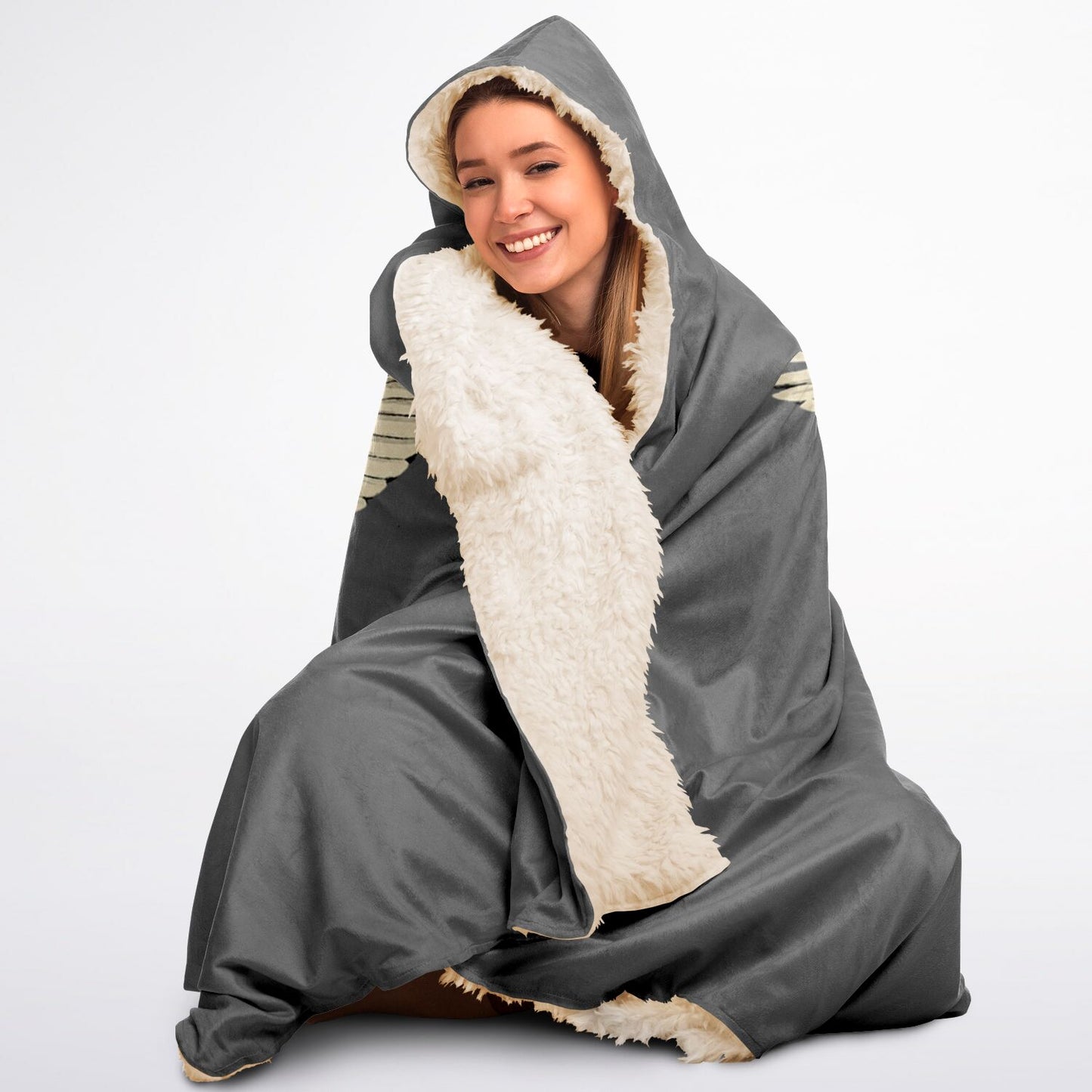 Person wearing a gray and white hooded blanket on a plain background