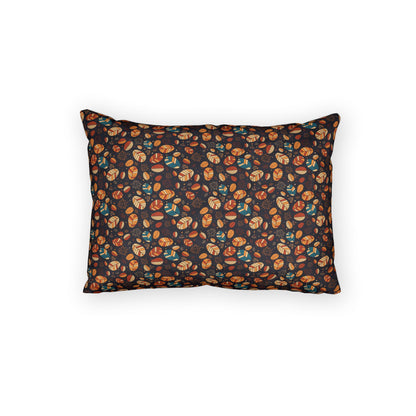 A rectangular throw pillow with a dark background and an all-over pattern of small illustrated pumpkins and acorns in orange, brown, and teal, shown on a plain white background.
