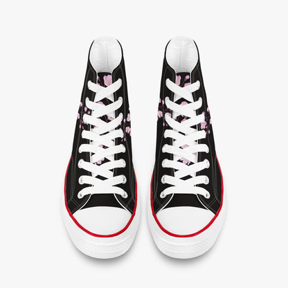 Black high-top sneakers with white laces and red soles on a white background