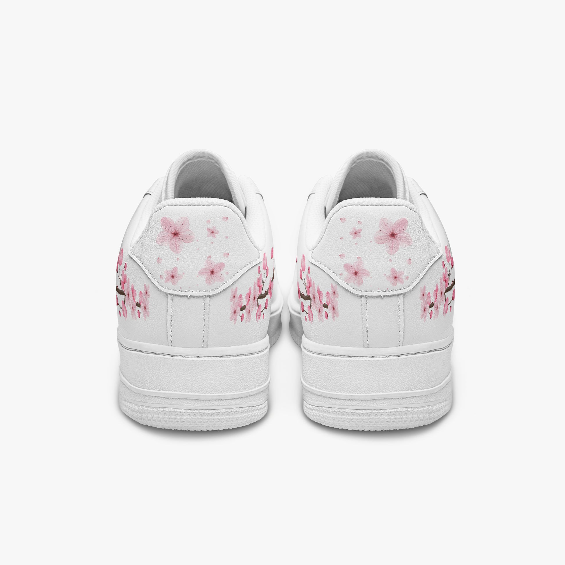 White sneakers with pink floral designs on a white background