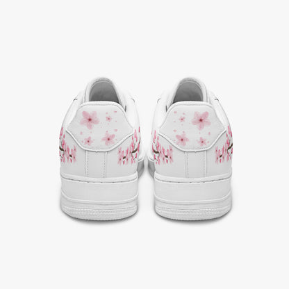 White sneakers with pink floral designs on a white background