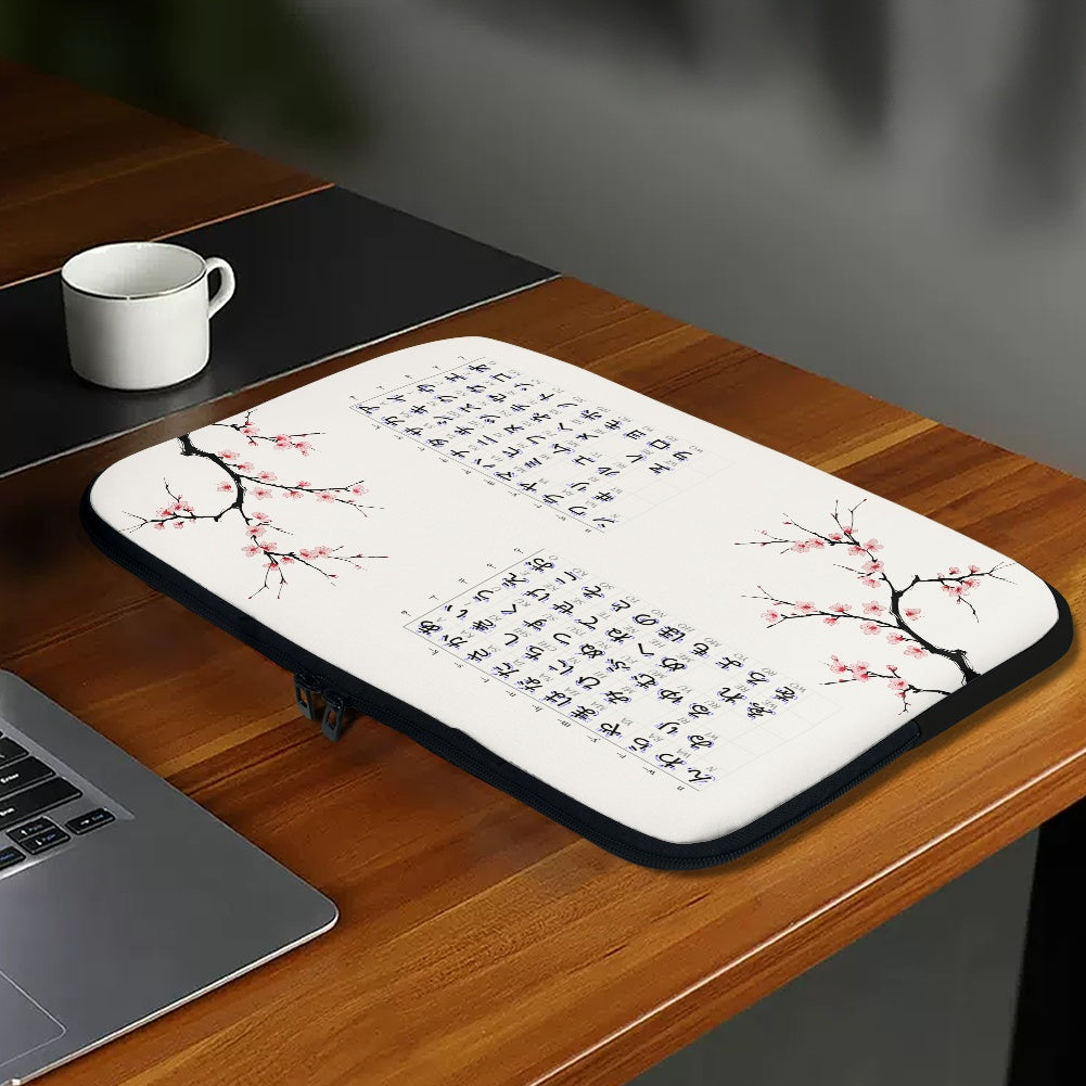 Laptop sleeve with cherry blossom design on a wooden desk