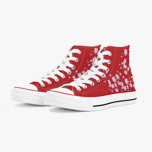 Red high-top sneakers with white floral pattern on a white background
