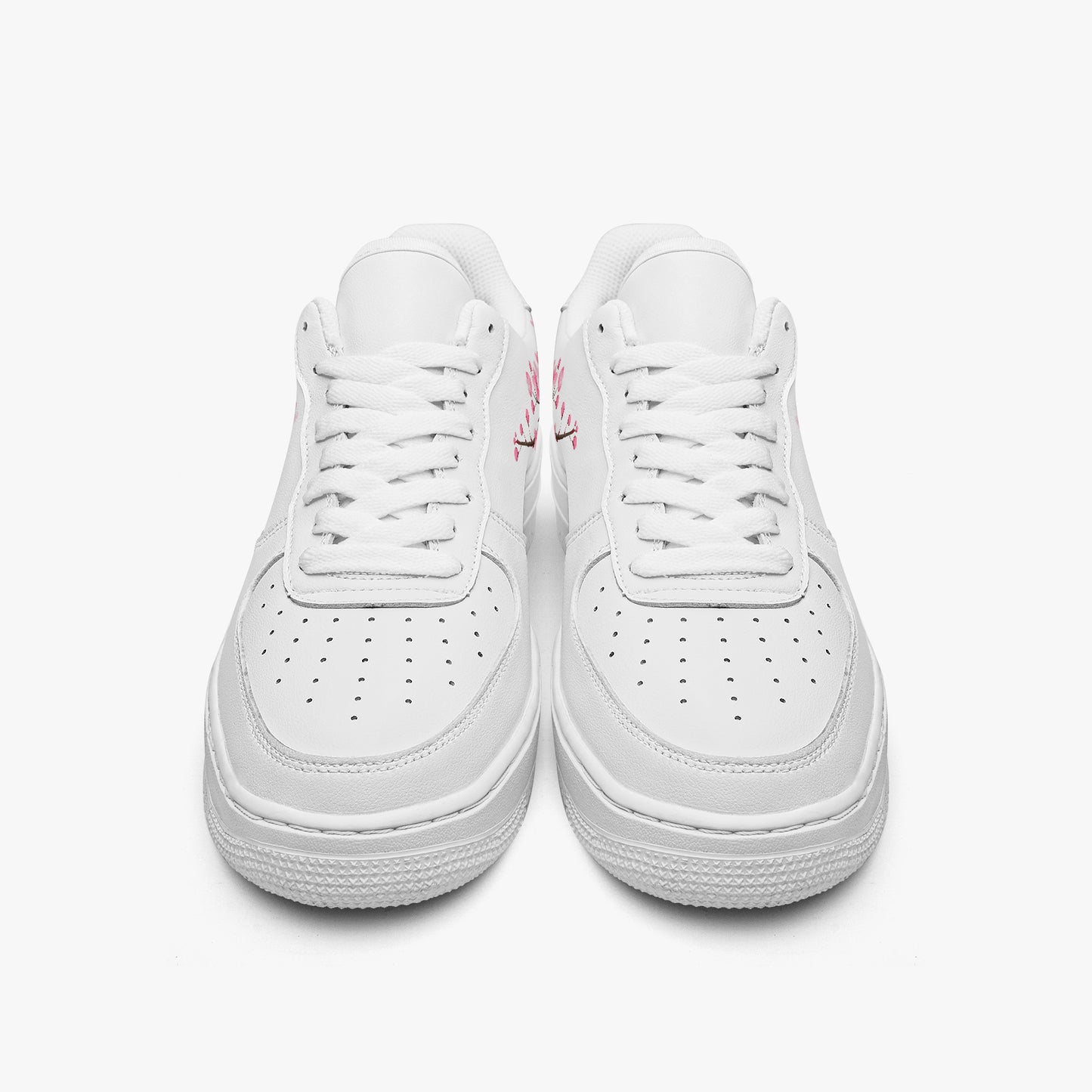 Pair of white sneakers on a light gray background