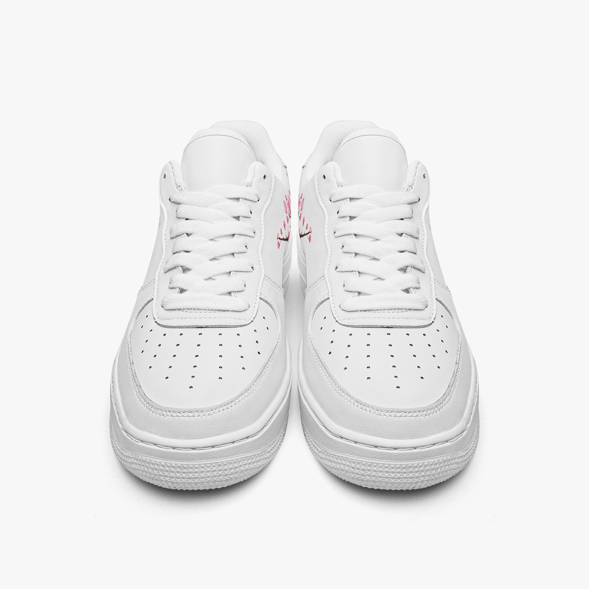 Pair of white sneakers on a light gray background