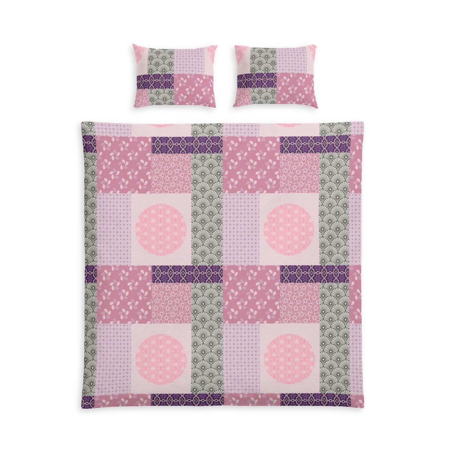 A patchwork quilt set featuring a duvet cover and two matching pillowcases in shades of pink, purple, and sage green, arranged on a plain white background.