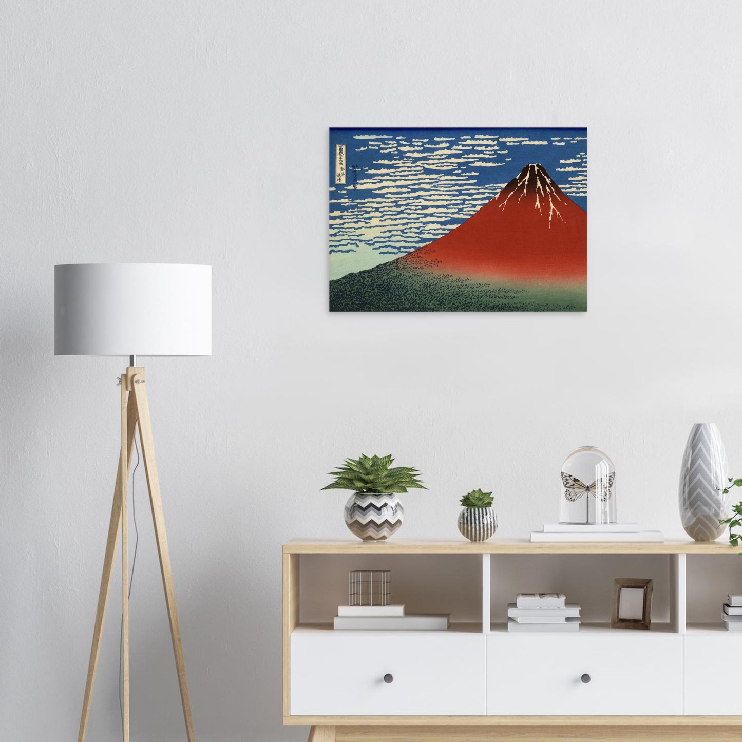 Room interior with a painting of Mount Fuji, a lamp, and a shelf with decorative items.