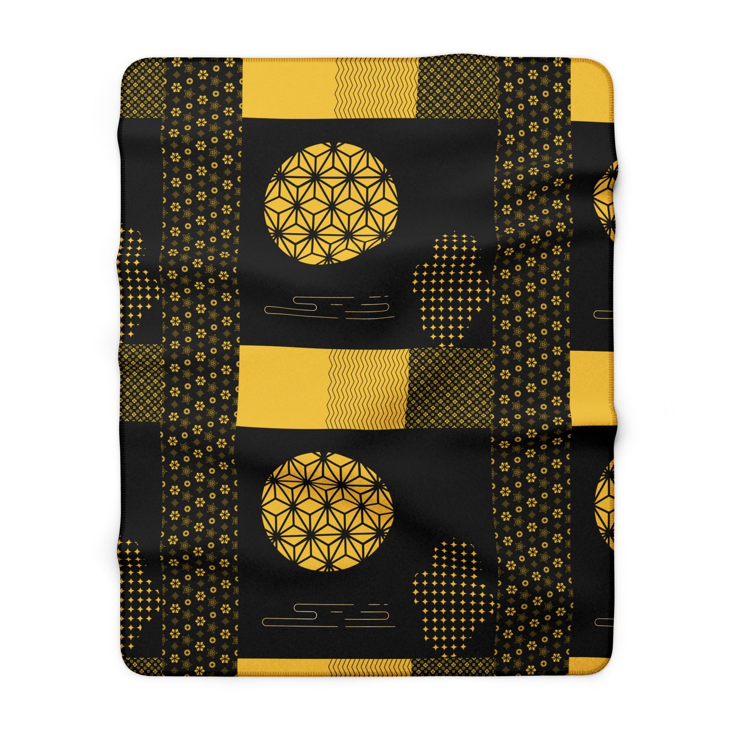 Black blanket with gold geometric patterns on a white background