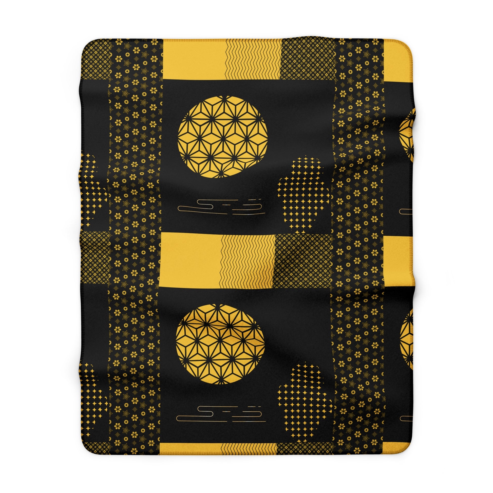 Black blanket with gold geometric patterns on a white background