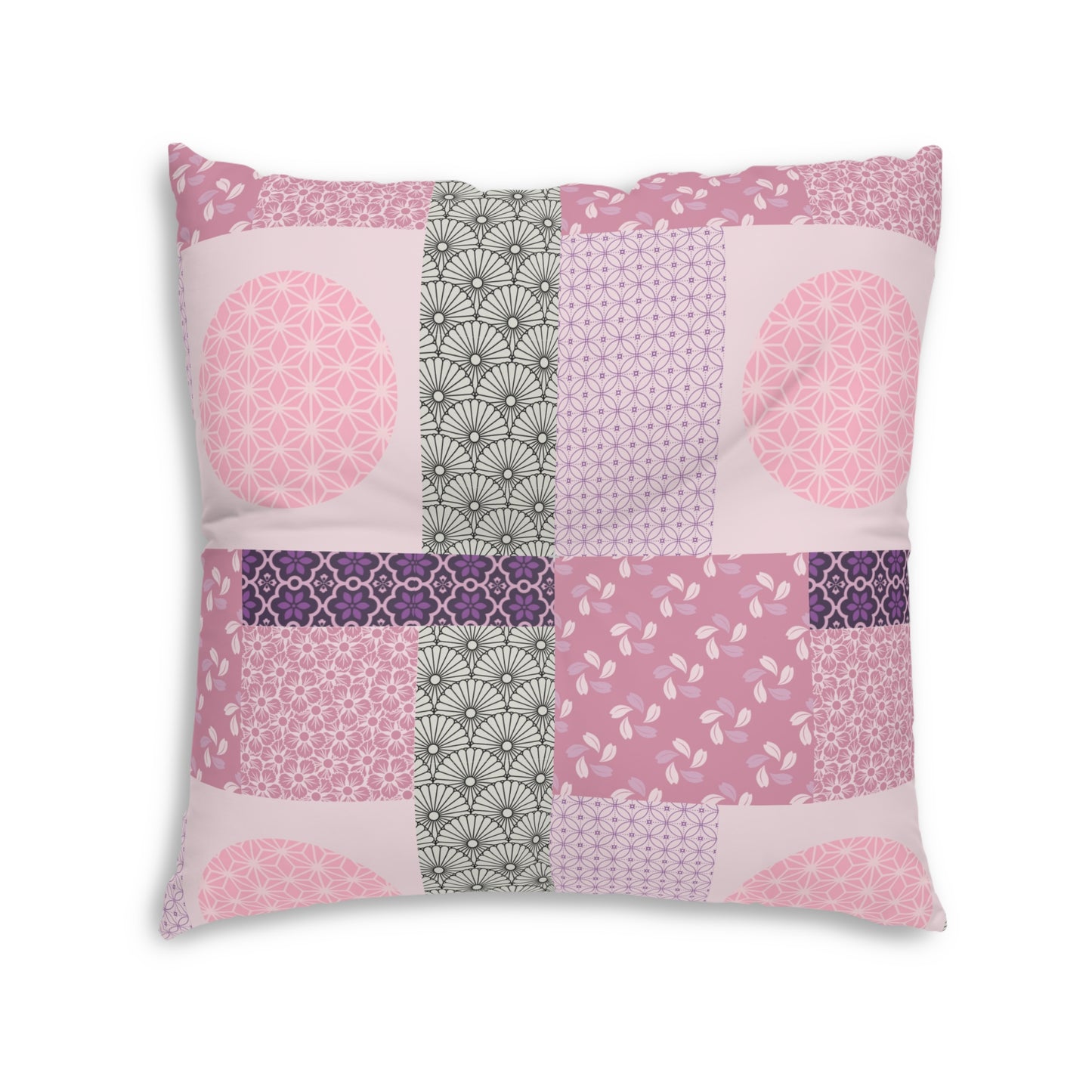A square decorative throw pillow featuring a patchwork design of various pink, purple, and gray Japanese-inspired patterns, set against a plain white background.
