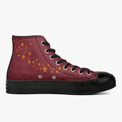 A high-top sneaker in burgundy canvas with a pattern of orange and yellow maple leaves on the side, black laces, a black rubber toe cap, and a black textured sole, shown against a plain white background.