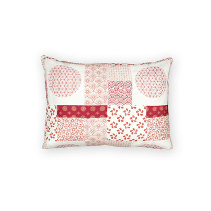 A rectangular decorative throw pillow featuring a patchwork design of various Japanese-inspired patterns in shades of pink, red, and white on a clean white background.