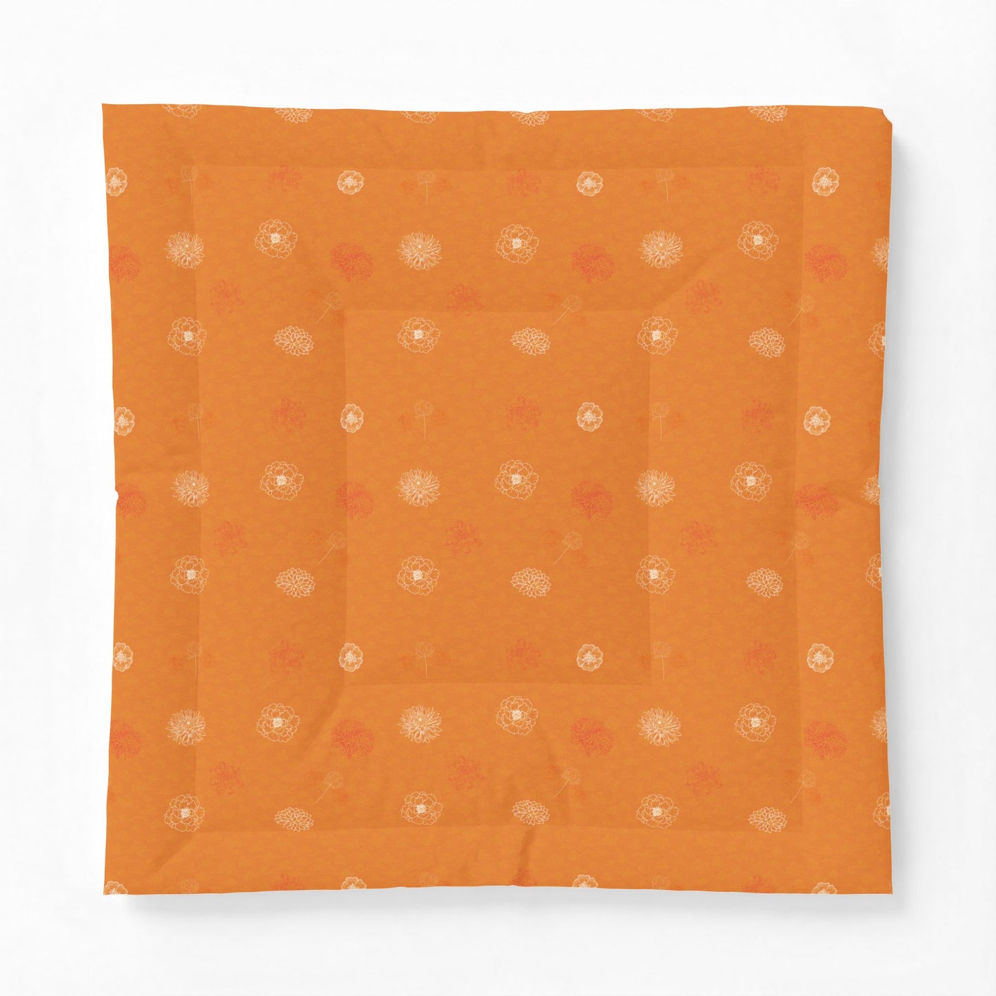 An orange square fabric item, likely a quilt or cushion cover, featuring a subtle pattern of small white and muted red floral motifs, displayed flat against a clean white background.