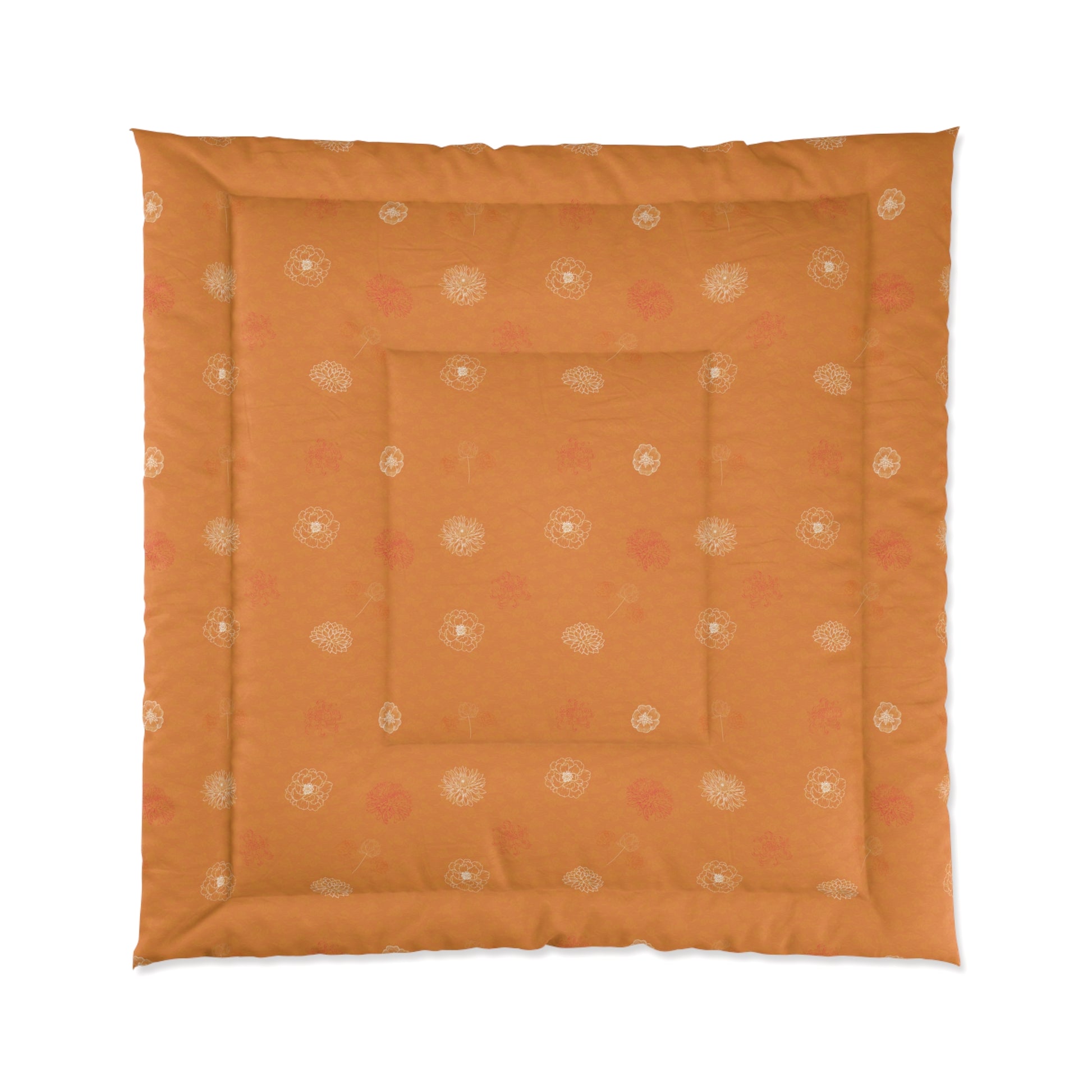 An orange square quilted floor cushion with a decorative border and central inset, featuring a subtle repeating floral pattern in cream and muted pink, shown against a plain white background.