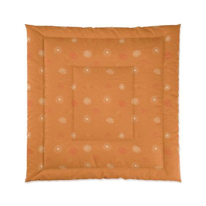 An orange square quilted floor cushion with a decorative border and central inset, featuring a subtle repeating floral pattern in cream and muted pink, shown against a plain white background.
