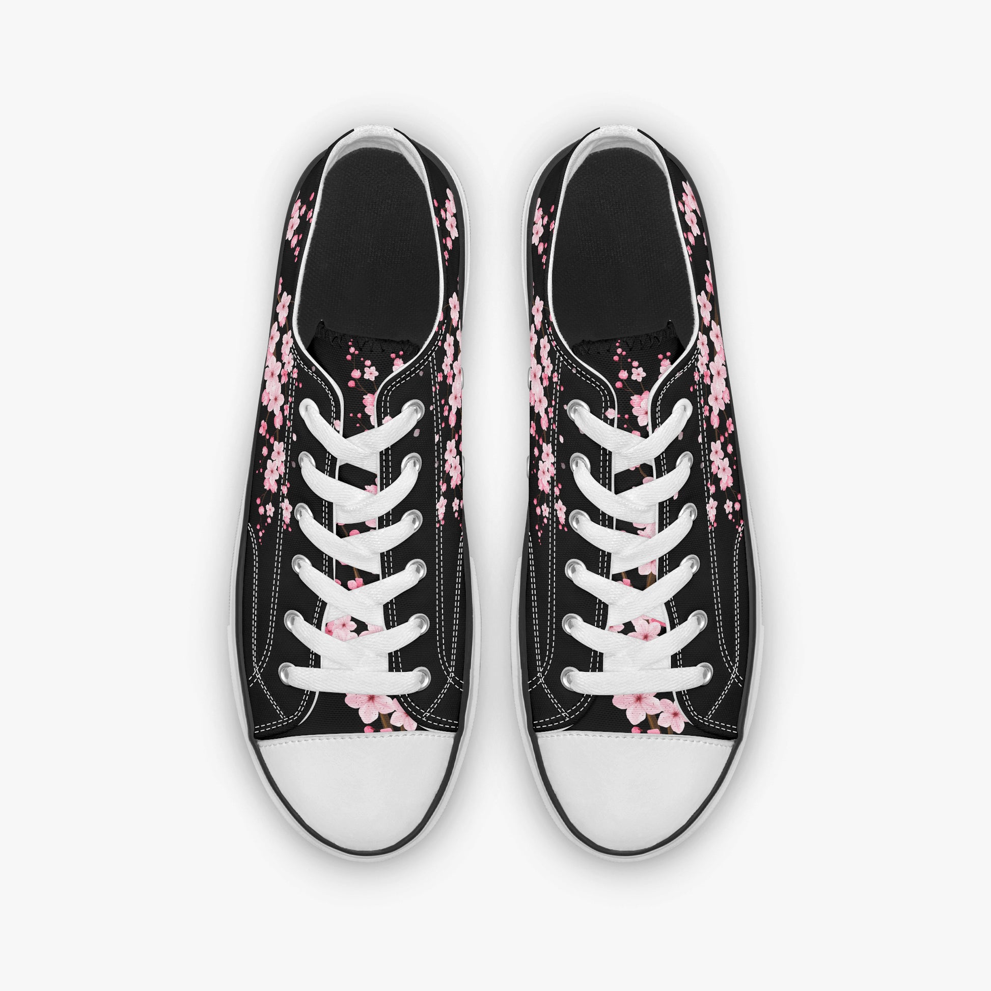 Black sneakers with pink floral patterns on a white background