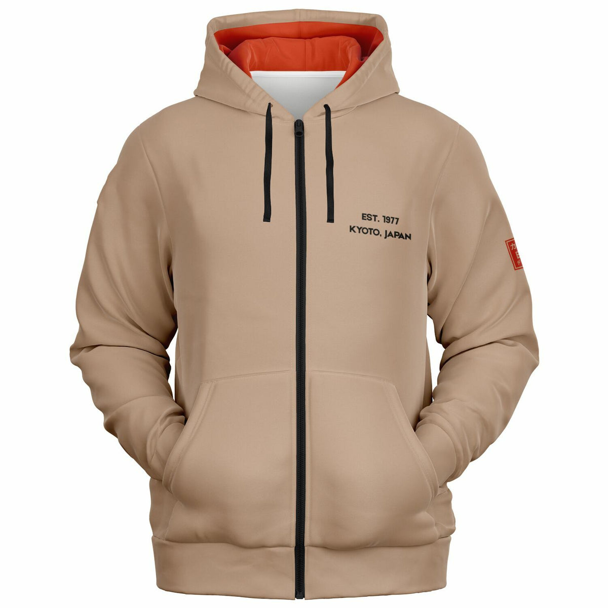 A beige zip-up hoodie with a black front zipper, black drawstrings, black printed text on the left chest reading 'EST. 1917 KYOTO, JAPAN', and a small red square patch on the right sleeve.