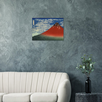Framed artwork of a mountain on a gray wall above a white sofa.