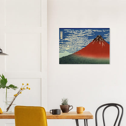 Framed artwork of Mount Fuji on a wall above a dining table with chairs.