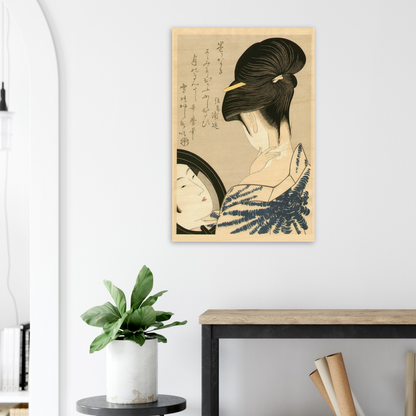 Framed artwork of a traditional Japanese scene on a wall above a desk with a plant.