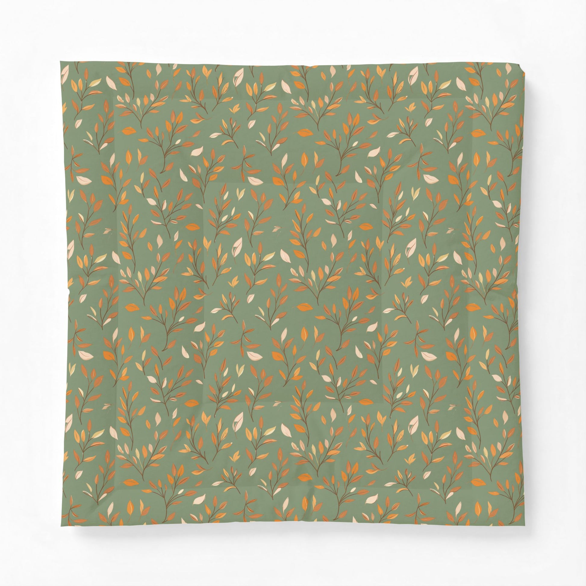 A square fabric item, likely a pillowcase or scarf, featuring an all-over botanical pattern of delicate branches and leaves in warm gold, brown, and cream tones on a muted sage green background.