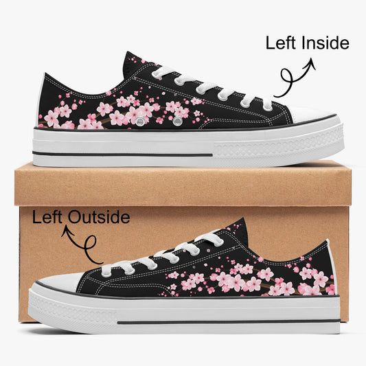 Black sneakers with pink floral pattern on a cardboard box