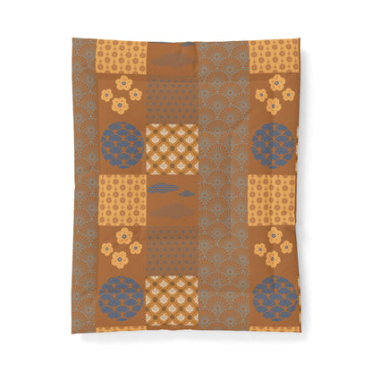 Patterned fabric with geometric shapes and floral elements on a brown background. Heritage Cotton