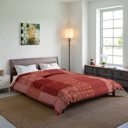 Bedroom with a bed covered in a red and white patterned comforter, a lamp, and a painting on the wall.