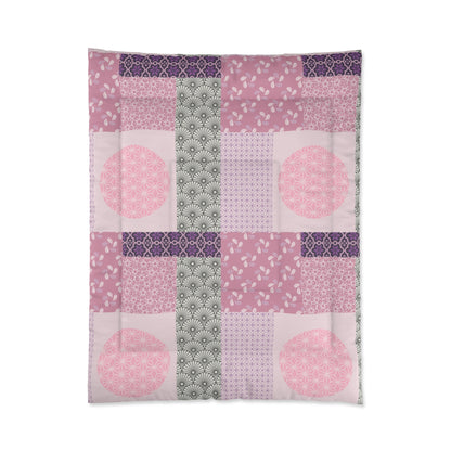Patchwork quilt with pink and purple patterns on a white background