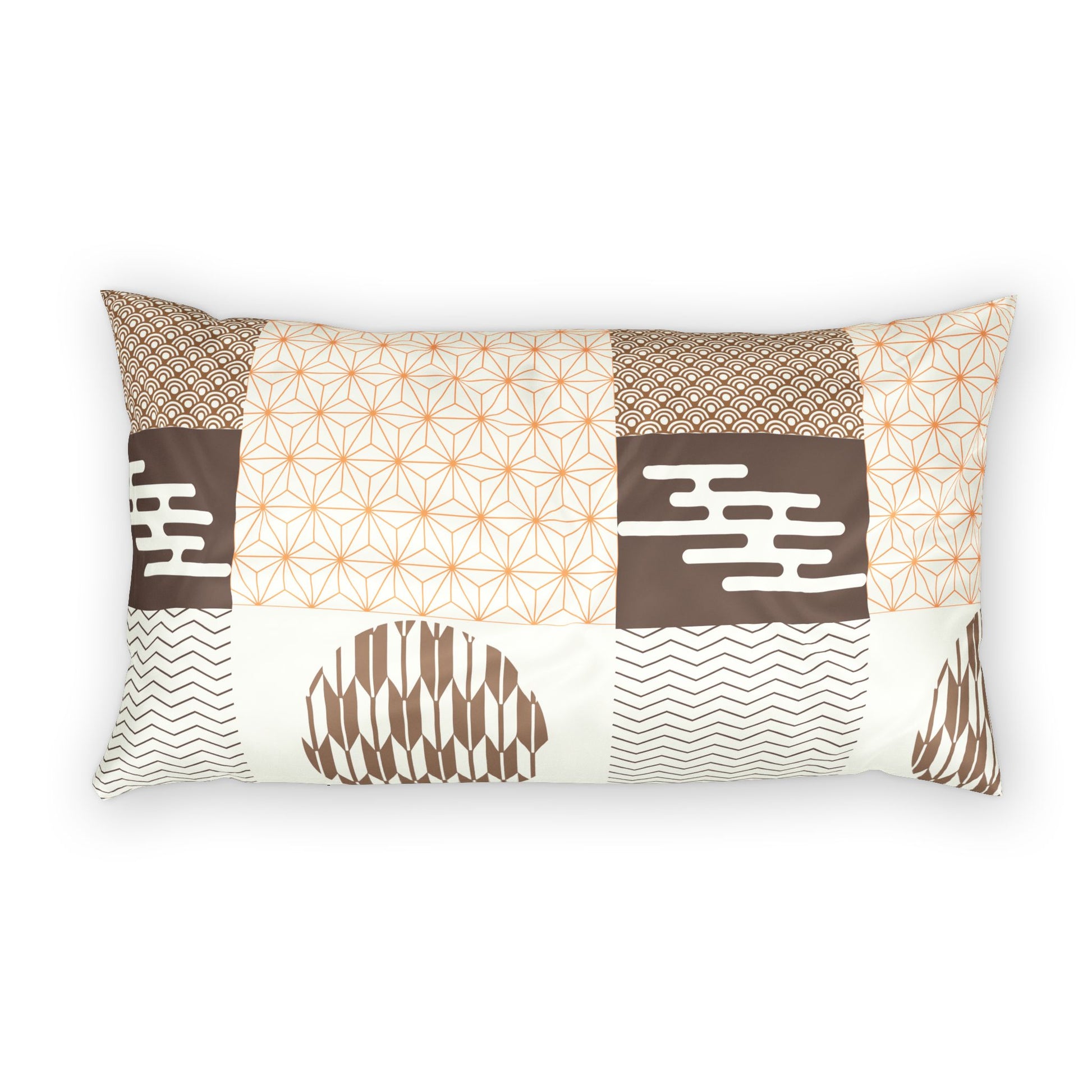 A rectangular lumbar pillow featuring a patchwork design with various geometric and tribal patterns in brown, beige, and white, set against a plain white background.