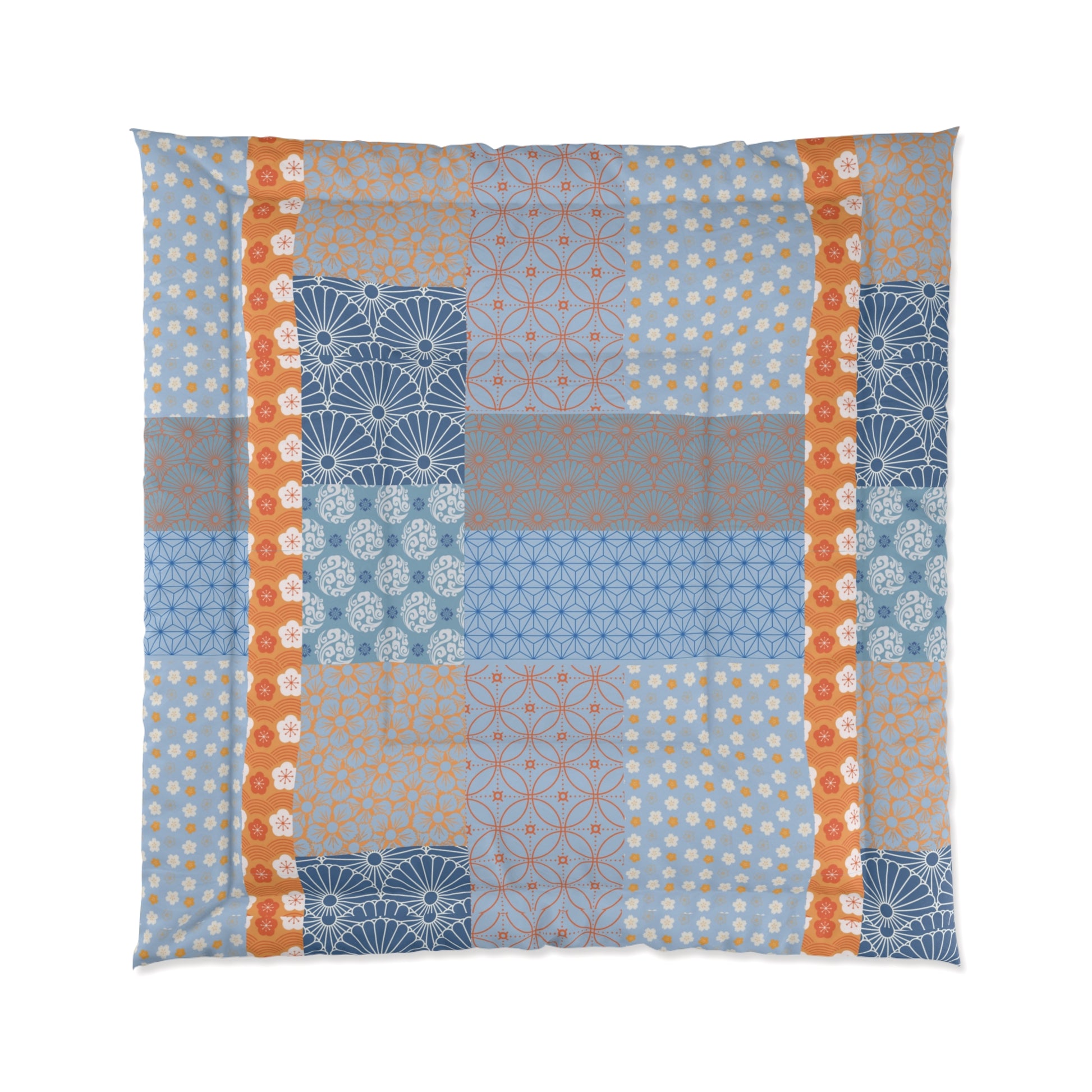 Patchwork quilt with geometric patterns in blue, orange, and gray on a white background