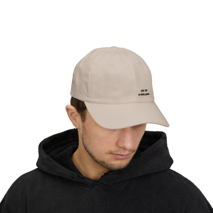Man wearing a beige cap with a logo on a white background