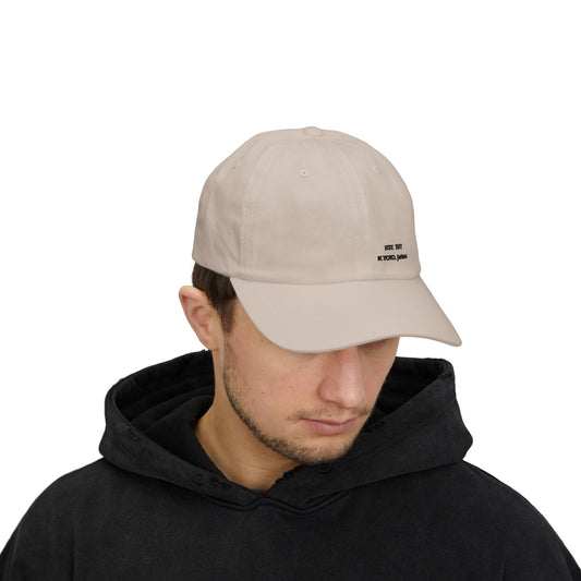 Man wearing a beige cap with a logo on a white background