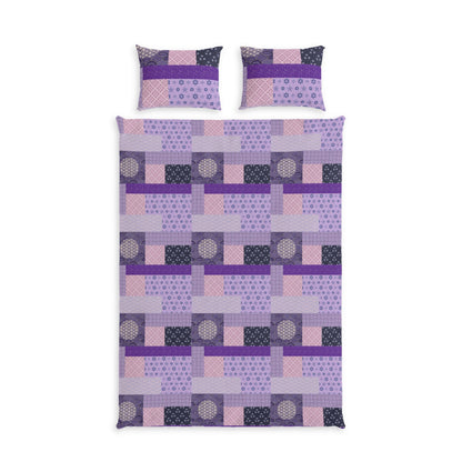 A bedding set featuring a duvet cover and two matching pillowcases with a geometric patchwork pattern in shades of purple, pink, and dark gray on a white background.