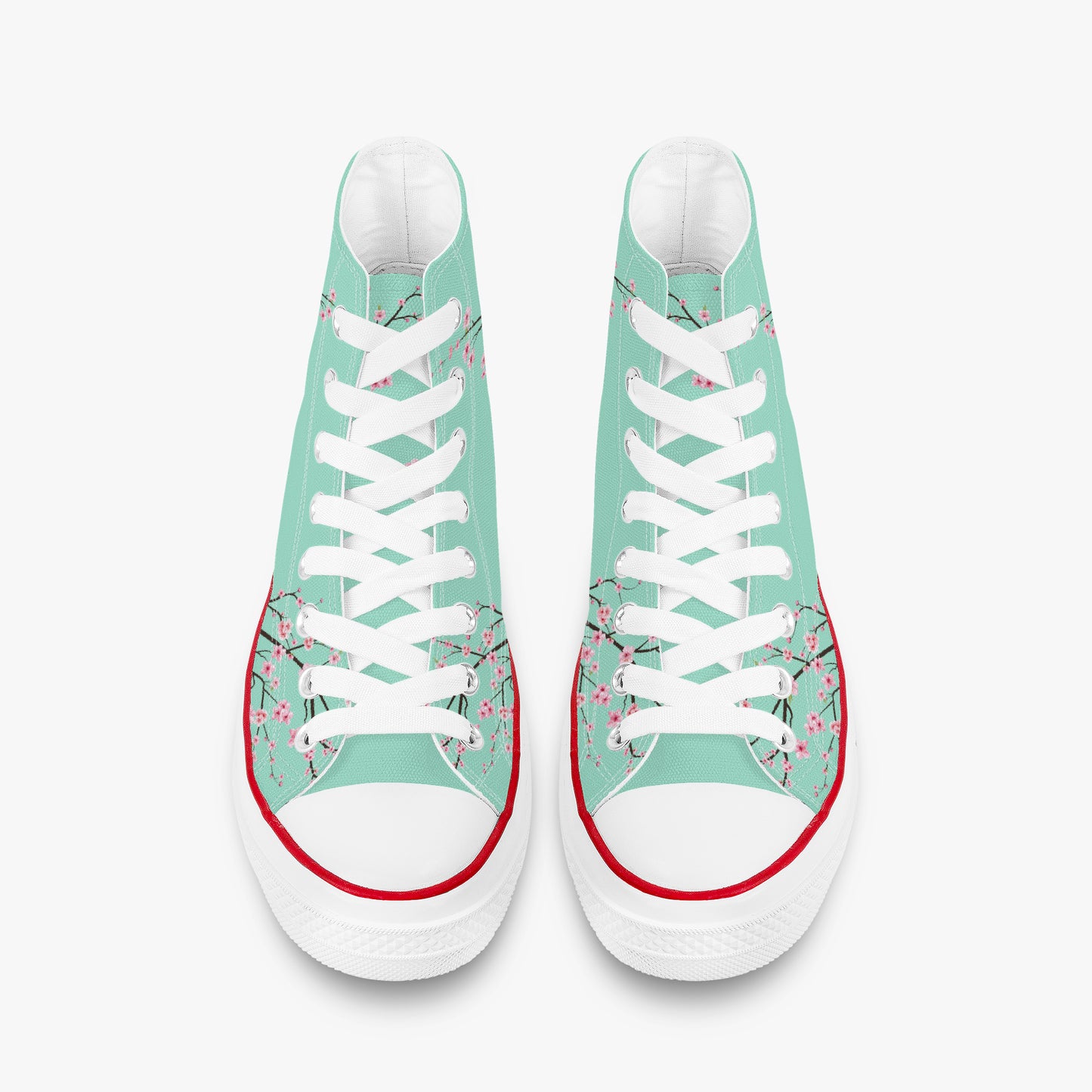 Pair of high-top sneakers with floral design on a light green background
