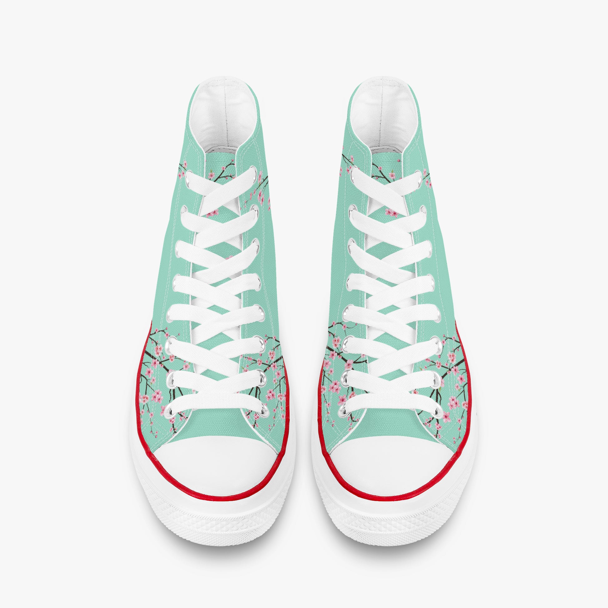 Pair of high-top sneakers with floral design on a light green background